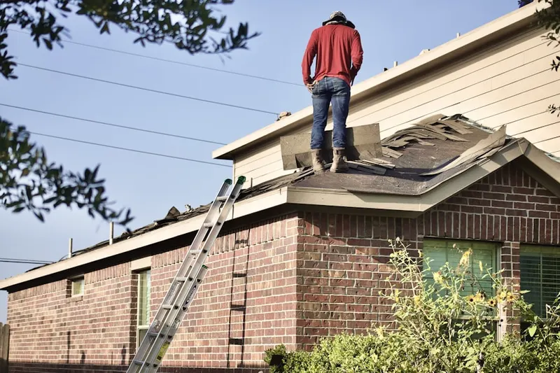 Professional roofer working on a residential roof in Cedar Isle